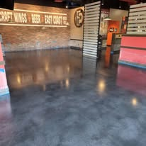 Gray coated concrete floor in a restaurant dining area