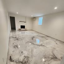 White and gray marble-style metallic epoxy floor in a finished basement