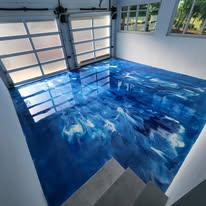 Deep blue metallic epoxy garage floor with a high-gloss finish