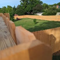 New wood privacy fence around a freshly graded and seeded backyard